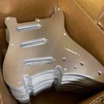 stack of aluminum S-500 pickguards