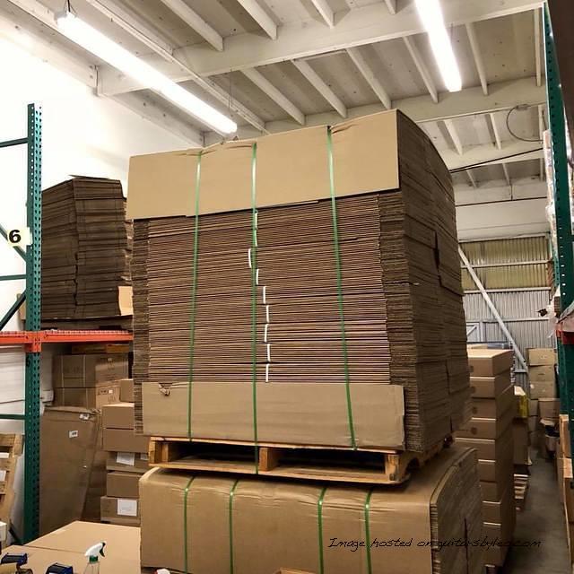 warehouse that has guitar boxes tape a forklift and stuff
