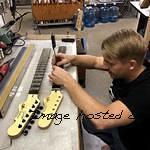 Patrick is dialing in fret height on some spare necks