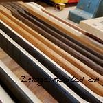 CS necks made of various types of wood await being slotted for frets