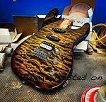 Custom Shop Legacy HSS RMC in Camo Burst over a 3A Quilted Maple top